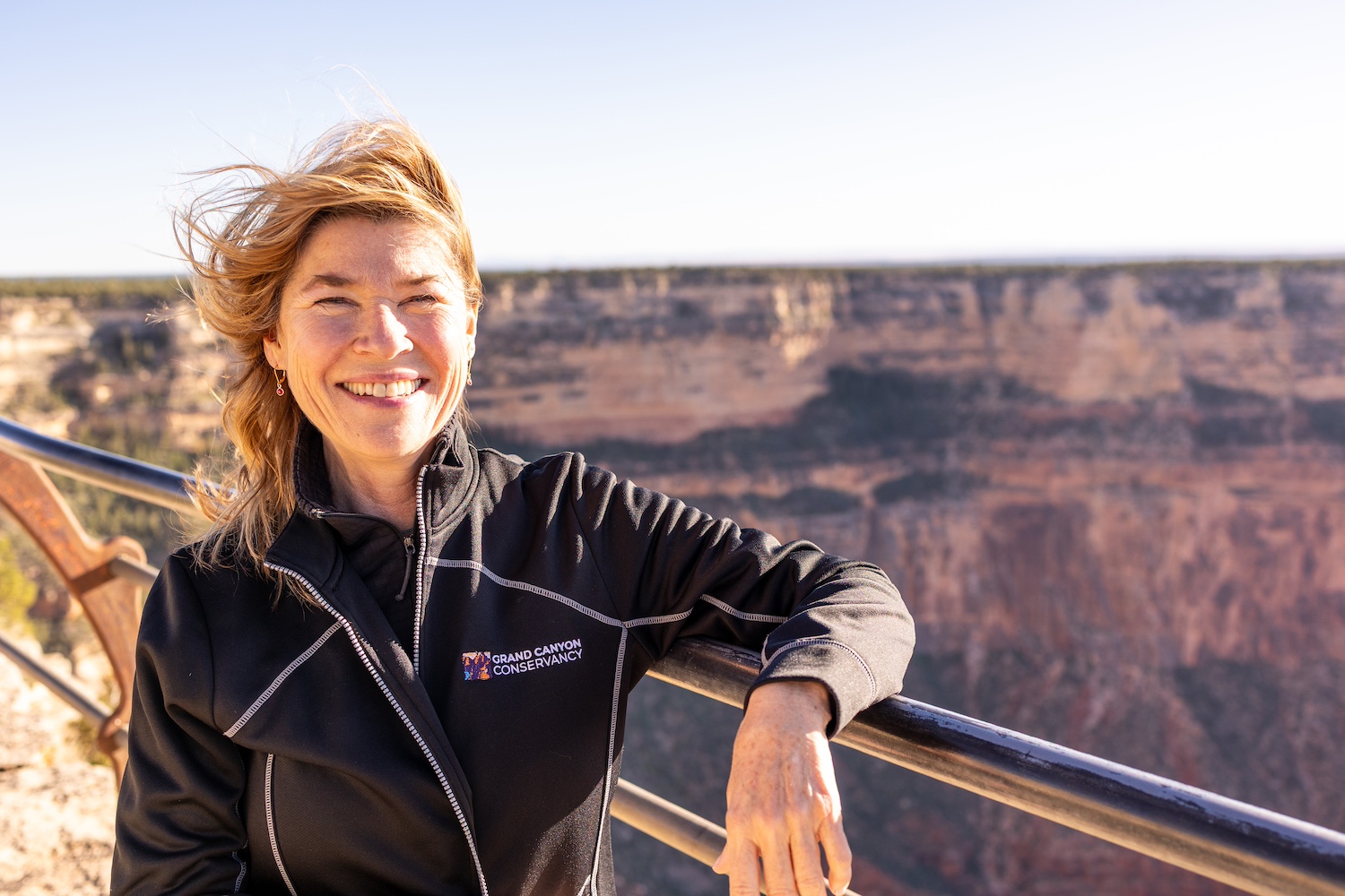 Elizabeth Silkes smiles at the camera with the Grand Canyon behind her — national parks